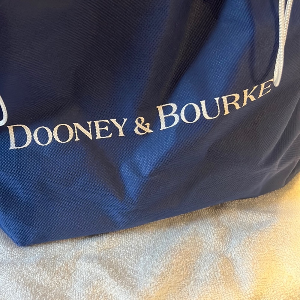 Dooney & Bourke, genuine leather bag, caramel colored. With duster bag